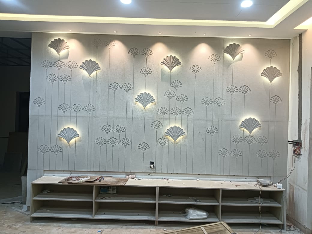 Custom entertainment media unit featuring backlit floral carved stone relief wall and concealed wiring